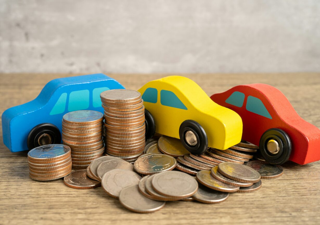 Car on stack of coins. Car loan, Finance, saving money, insurance and leasing time concepts.