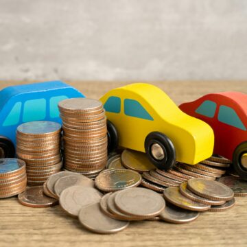 Car on stack of coins. Car loan, Finance, saving money, insurance and leasing time concepts.