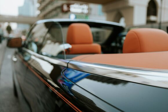 Close up of luxury cabriolet convertible car with orange leather interior