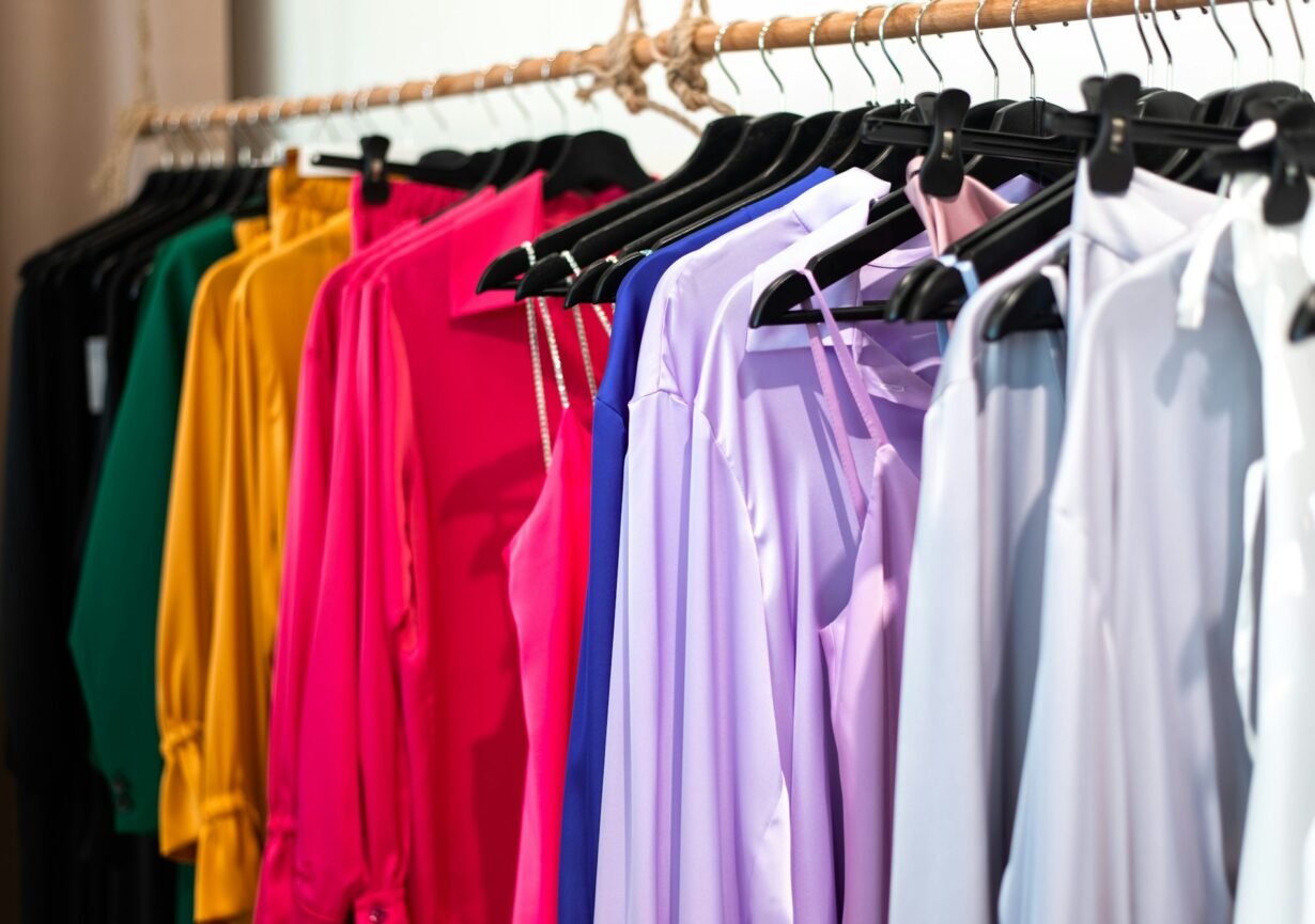 clothes bright colors on hangers in the store