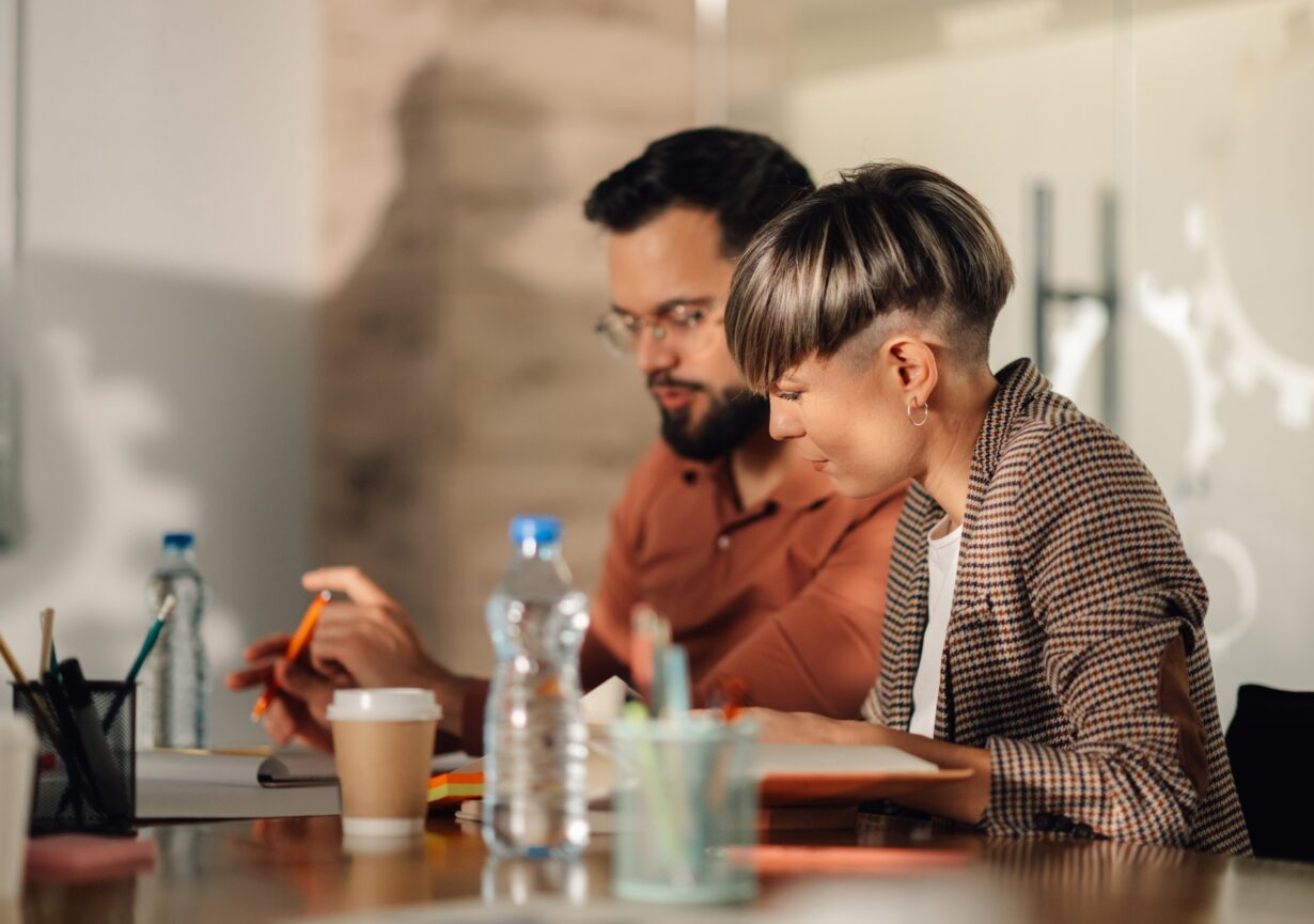 Colleagues working together on a project in modern office