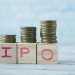 IPO text ,Initial Public Offering on wooden block with stack of coins