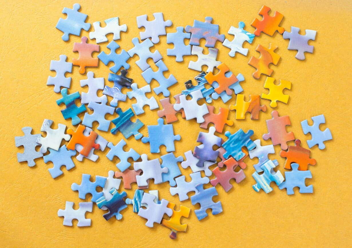 Scattered puzzle pieces on a yellow background