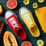 Summer clothes concept with sneakers on wooden background